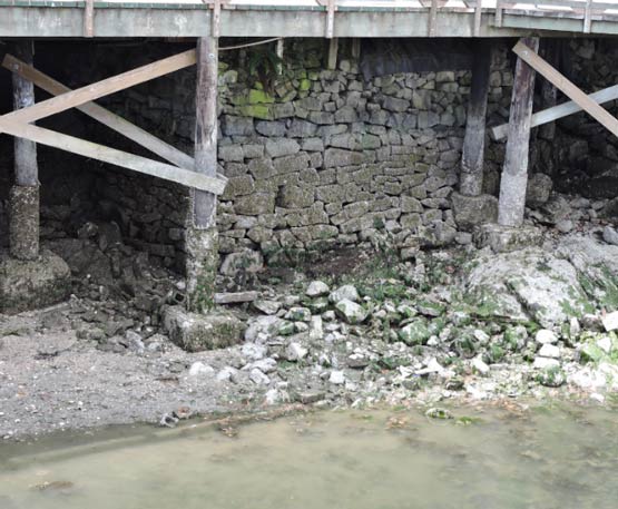 photo showing the drystone wall under the boardwalk by the Mouat’s store