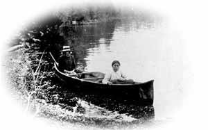 historical photo of people in a canoe
